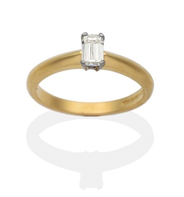 Lot 2077 - An 18 Carat Gold Octagonal Cut Solitaire Diamond Ring, in a claw setting, to ridged shoulders,...