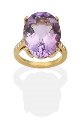 Lot 2079 - An 18 Carat Gold Amethyst and Diamond Ring, an oval cut amethyst in a claw setting, to diamond...