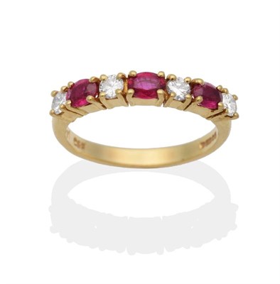 Lot 2082 - An 18 Carat Gold Ruby and Diamond Half Hoop Ring, oval cut rubies spaced by round brilliant cut...