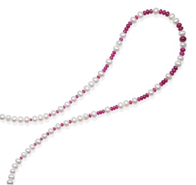 Lot 2086 - A Ruby and Cultured Pearl Necklace, graduated smooth ruby beads spaced by groups of cultured...