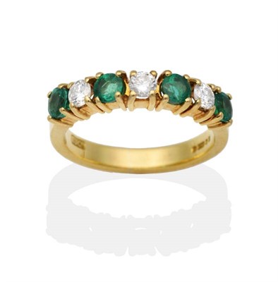 Lot 2087 - An 18 Carat Gold Emerald and Diamond Half Hoop Ring, alternating round cut emeralds and round...