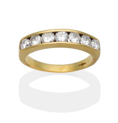 Lot 2089 - An 18 Carat Gold Diamond Half Hoop Ring, seven channel set round brilliant cut diamonds to a...