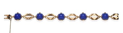 Lot 2099 - A Blue Chalcedony Bracelet, sugarloaf cabochon blue chalcedony in double claw settings as...