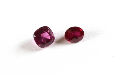 Lot 2101 - A Loose Oval Cut Ruby, weighing 0.67 carat approximately; and A Loose Round Cut Pink Sapphire,...