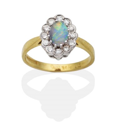 Lot 2115 - An 18 Carat Gold Opal and Diamond Cluster Ring, an oval cabochon opal in a claw setting within...