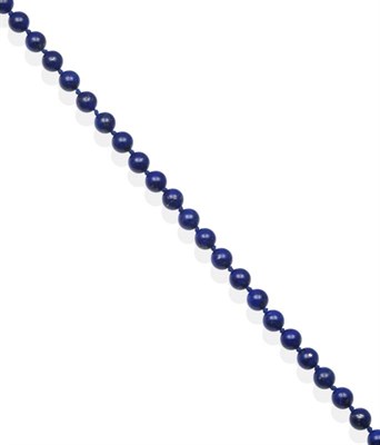 Lot 2116 - A Lapis Lazuli Bead Necklace, uniform lapis lazuli beads knotted to a ball clasp, length 50cm...