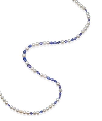 Lot 2120 - A Tanzanite and Pearl Necklace, smooth oval tanzanite beads spaced by groups of cultured...