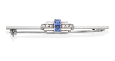 Lot 2130 - An Art Deco Sapphire and Diamond Brooch, two square cut sapphires in milgrain settings, to...