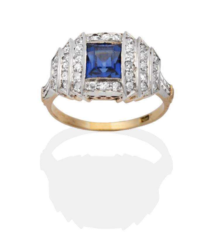 Lot 2131 - An Art Deco Sapphire and Diamond Ring, a square cut sapphire within a square stepped frame of...