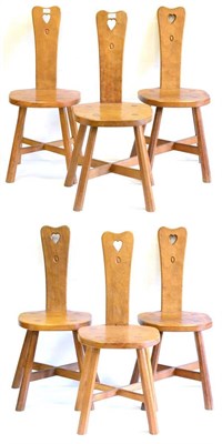 Lot 582 - A Set of Six Alan Grainger Acorn Industries Oak Spinning Chairs, the backs with carved heart motif