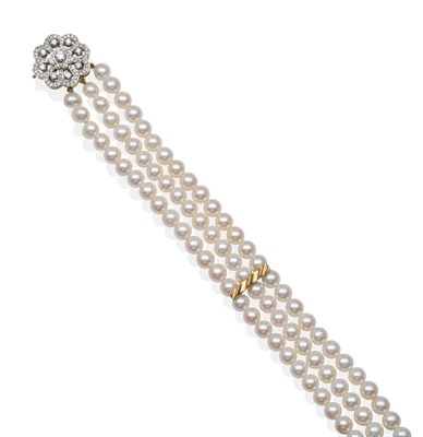Lot 2135 - An 18 Carat Gold Triple Strand Cultured Pearl Choker, with a Diamond Clasp, uniform cultured pearls