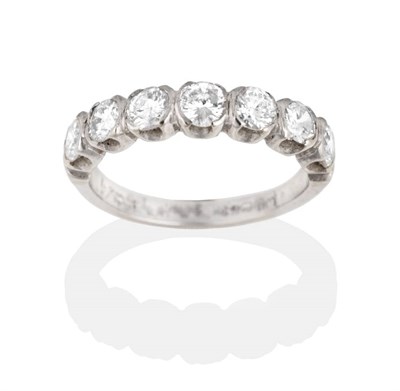 Lot 2137 - An 18 Carat White Gold Diamond Half Hoop Ring, seven round brilliant cut diamonds in rubbed...