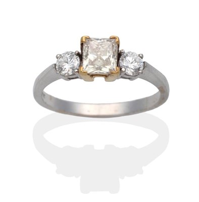 Lot 2139 - An 18 Carat White Gold Diamond Three Stone Ring, a fancy yellow princess cut diamond spaced by...