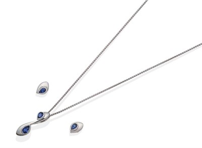 Lot 2142 - An 18 Carat White Gold Sapphire Pendant and Earring Suite; the pendant with two pear cut...