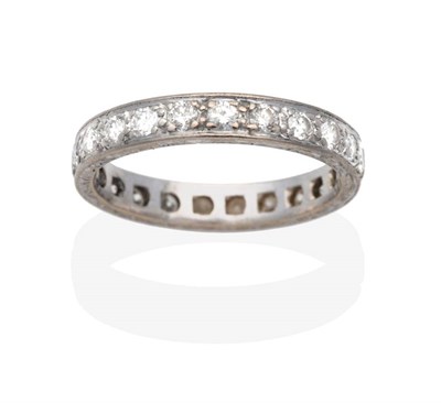Lot 2144 - A Diamond Eternity Ring, round brilliant cut diamonds to a chased shank, total estimated...