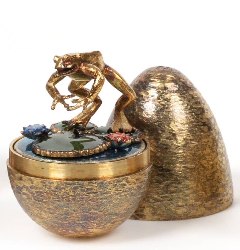 Lot 2441 - Stuart Devlin: A Silver Gilt Surprise Egg, London 1987, the interior featuring a frog leaping...