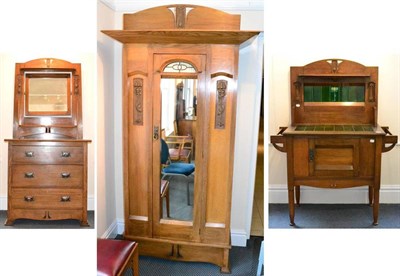 Lot 618 - An Arts & Crafts Oak Bedroom Suite, comprising a wardrobe, with shaped pediment above an over...