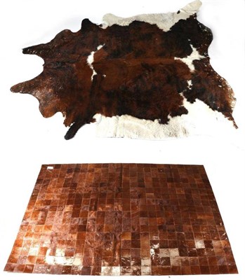 Lot 191 - Taxidermy: Cowhide Floor Rug (Bos taurus), modern, a large tanned brown white and black cow...