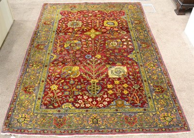 Lot 900 - Indian Rug The raspberry field of Shah Abass design enclosed by steel grey borders of palmettes and