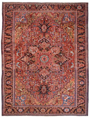 Lot 910 - Heriz Carpet Persian Azerbaijan The madder field of angular vines centred by a typical indigo...