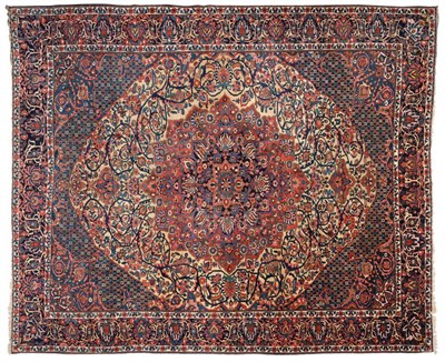 Lot 915 - Bakhtiari Carpet West Persia The lemon field of scrolling vines around a stepped madder and...