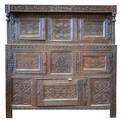 Lot 1055 - A Carved Oak Court Cupboard, with initials RH and dated 1689, carved overall with guilloche symbols