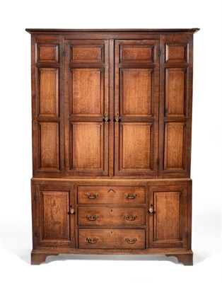 Lot 1075 - An 18th Century English Joined Oak Housekeeper's Cupboard, the bold cornice above two fielded panel