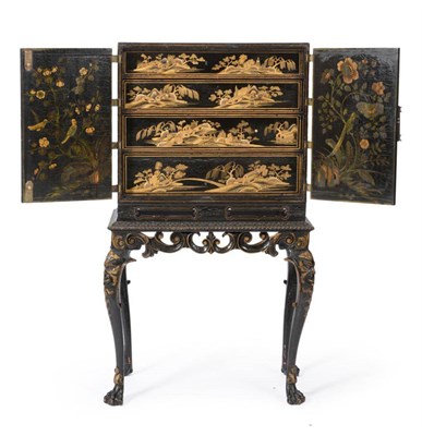 Lot 1103 - An Early 18th Century Japanese Black Lacquer Cabinet on Stand, with engraved brass hinges and...