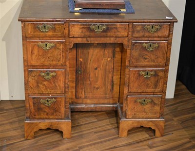 Lot 1115 - A George I Walnut and Crossbanded Kneehole Dressing Table, early 18th century, the quarter-veneered