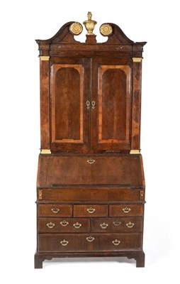 Lot 1136 - A Walnut Bureau Bookcase, in three sections, the swan neck pediment above two cupboard doors...