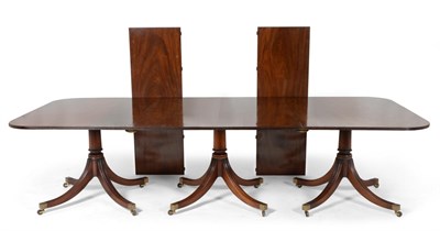 Lot 1165 - A George III Style Mahogany Triple Pillar Dining Table , the rounded rectangular top with...