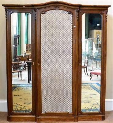 Lot 1222 - A French Walnut Breakfront Wardrobe, late 19th century, the moulded domed top cornice above a...