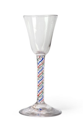 Lot 1 - A Colour Twist Wine Glass, circa 1755, the rounded funnel bowl on a blue, red, green and white...