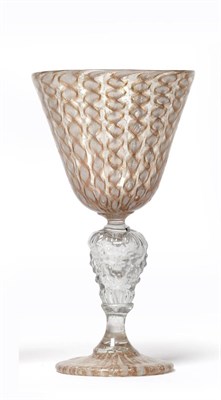 Lot 16 - A Façon de Venise Latticino Wine Glass, probably 17th century, the rounded funnel bowl with...