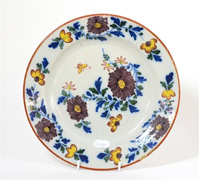 Lot 36 - An English Delft Dish, circa 1760, painted in colours with chinoiserie foliage within a brown...