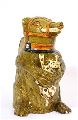 Lot 51 - A Pratt-Type Bear Jug and Cover, 19th century, the seated animal with green markings, an ochre...