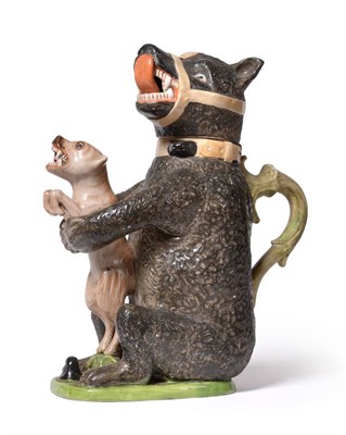 Lot 53 - A Staffordshire Pottery Bear Jug and Cover, 19th century, the seated animal clutching a struggling