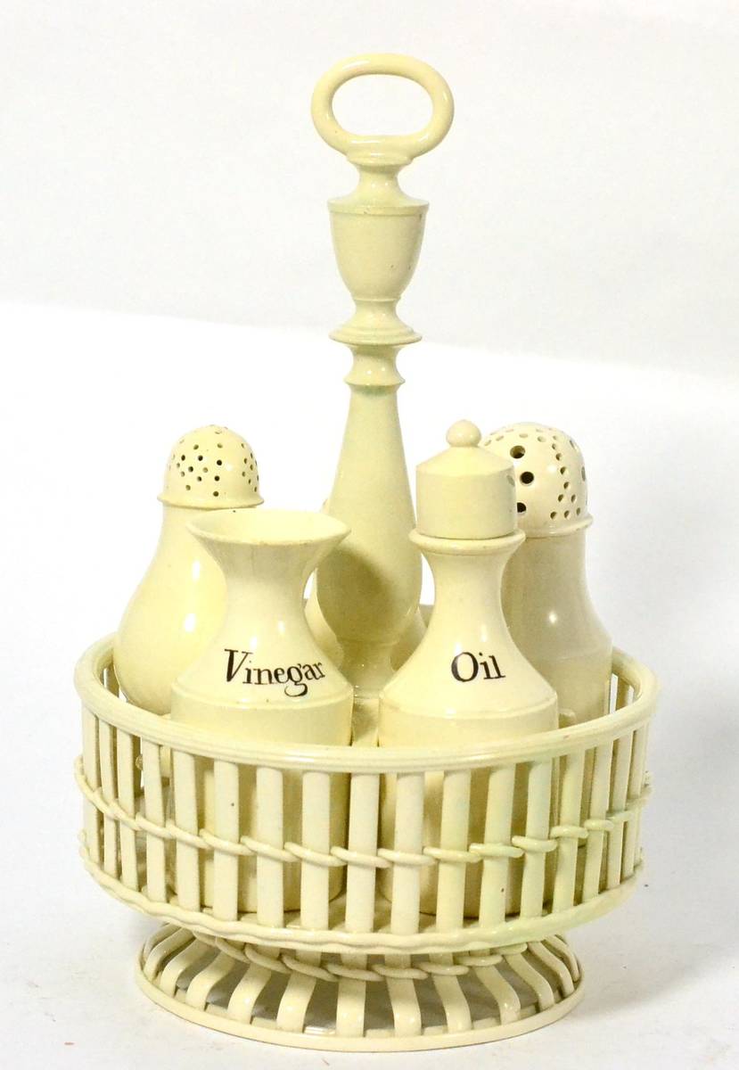 Lot 56 - A Creamware Cruet Set, late 18th century, the stand with loop and urn finial, baluster stem and...