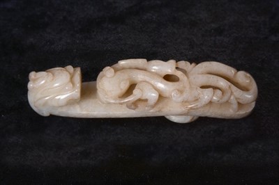Lot 126 - A Chinese Jade Belt Hook, carved as chilong and with mask terminal, 11cm long See illustration