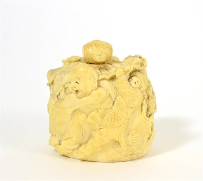 Lot 137 - A Japanese Carved Ivory Box and Cover, Meiji period, carved with figures about a large sack, signed