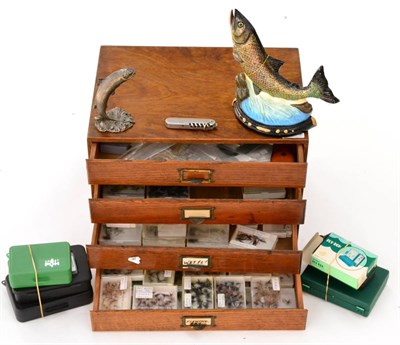 Lot 2108 - A Four Drawer Oak Cabinet Containing Flies, together with fly boxes, fisherman's knife and two...