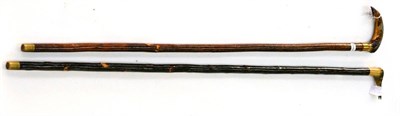 Lot 2254 - Two Rams Horn Show Sticks - heron and fish on chestnut and leaping trout on hazel