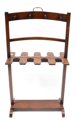 Lot 2059 - A Mahogany Boot Stand, with eight slots for boots and eight hangers, brass carrying handle,...