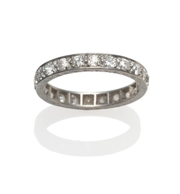 Lot 204 - An Early 20th Century Diamond Eternity Ring, the old cut diamonds claw set in a flat engraved sided