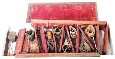 Lot 1067 - A Cased Set of Nine 19th Century Steel Cockfighting Spurs, eight with leather straps, in a...