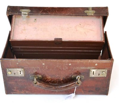 Lot 1173 - An Early 20th Century Stitched Leather Tackle Box, containing five concertina action trays