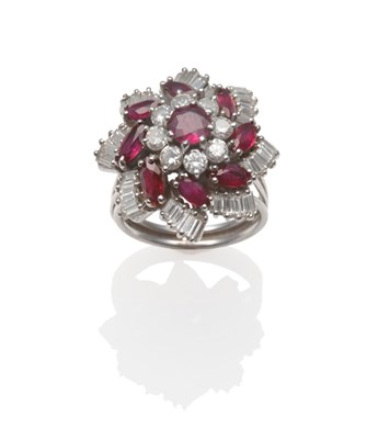 Lot 240 - A Ruby and Diamond Cluster Ring, a round cut ruby within a border of round brilliant cut...