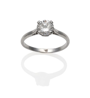 Lot 241 - A Diamond Solitaire Ring, the round brilliant cut diamond in a white four claw setting, to a...