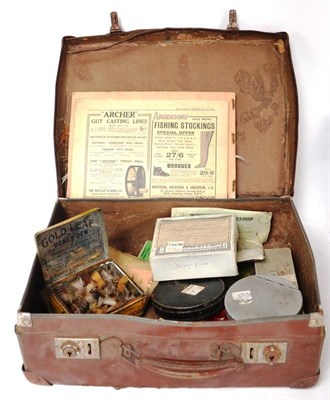 Lot 1213 - A Case of Fishing Accessories, including a book of feather samples, Fishing Gazette 1921, tins...