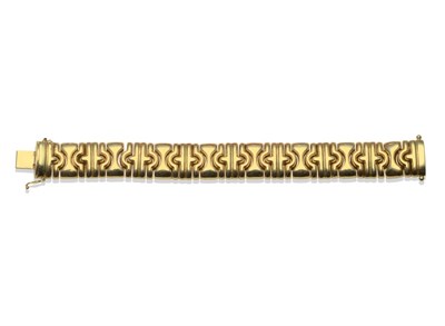 Lot 255 - An 18 Carat Gold Fancy Link Bracelet, the broad yellow polished links of mixed curved and...